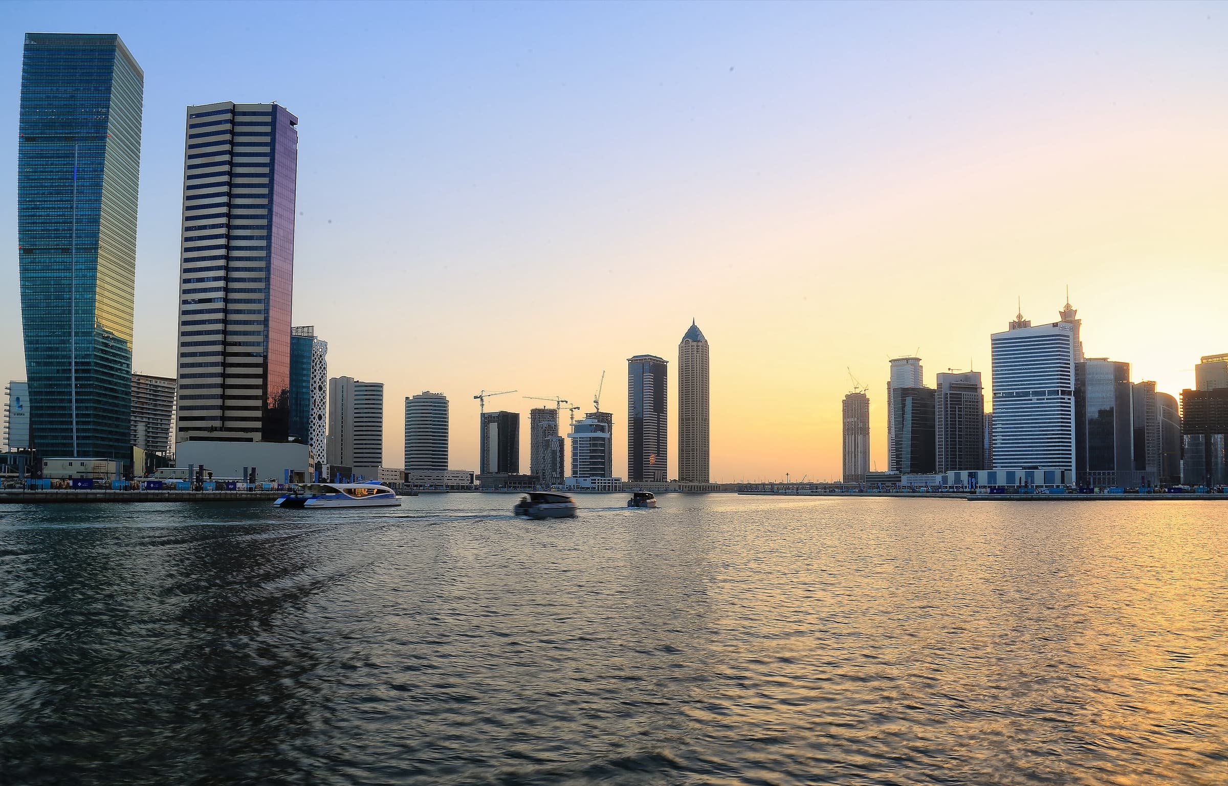 Business Bay towers along the Dubai Water Canal at golden hour
