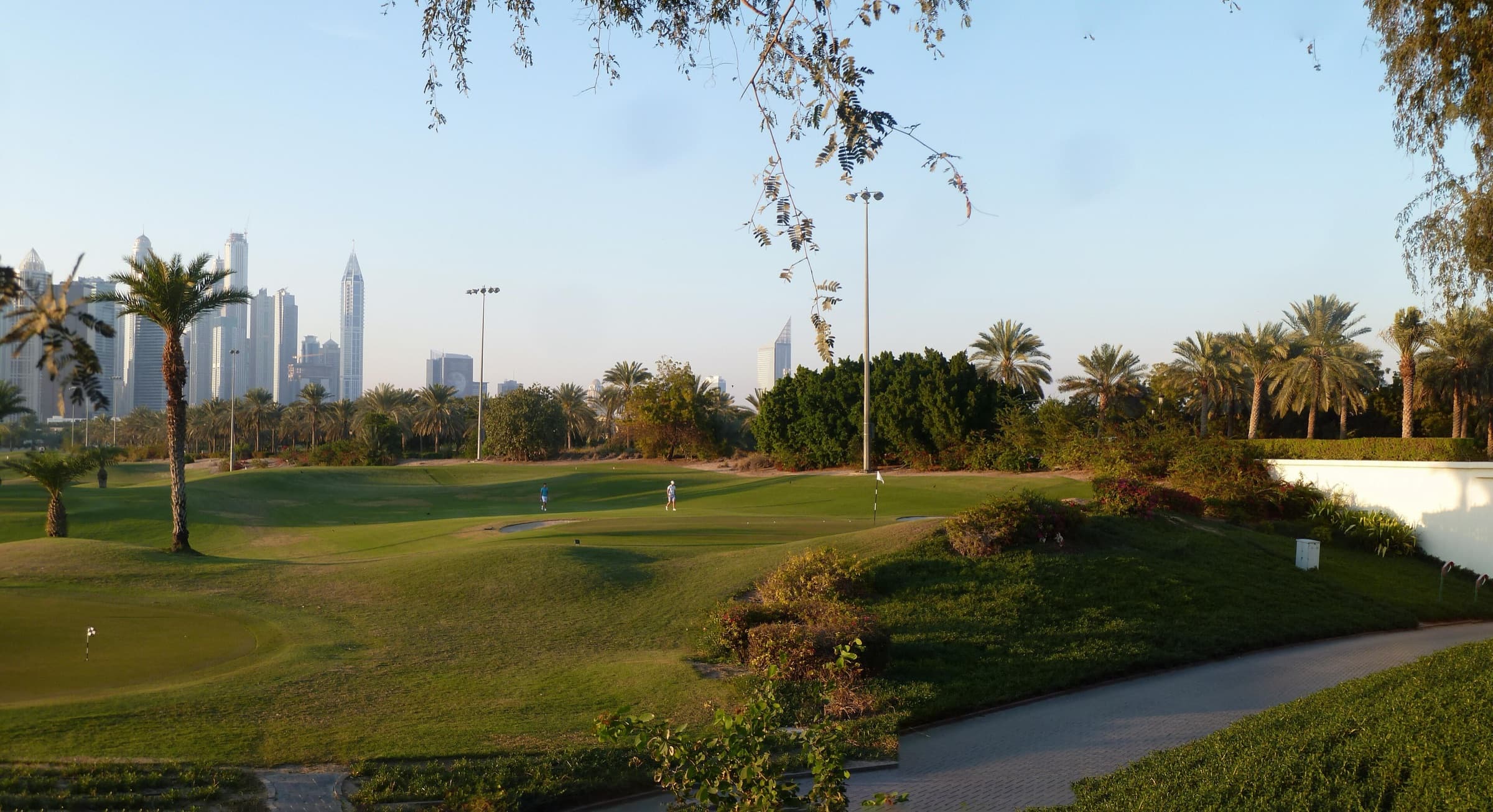 Golf course fairway in Emirates Hills with the Dubai Marina towers on the horizon