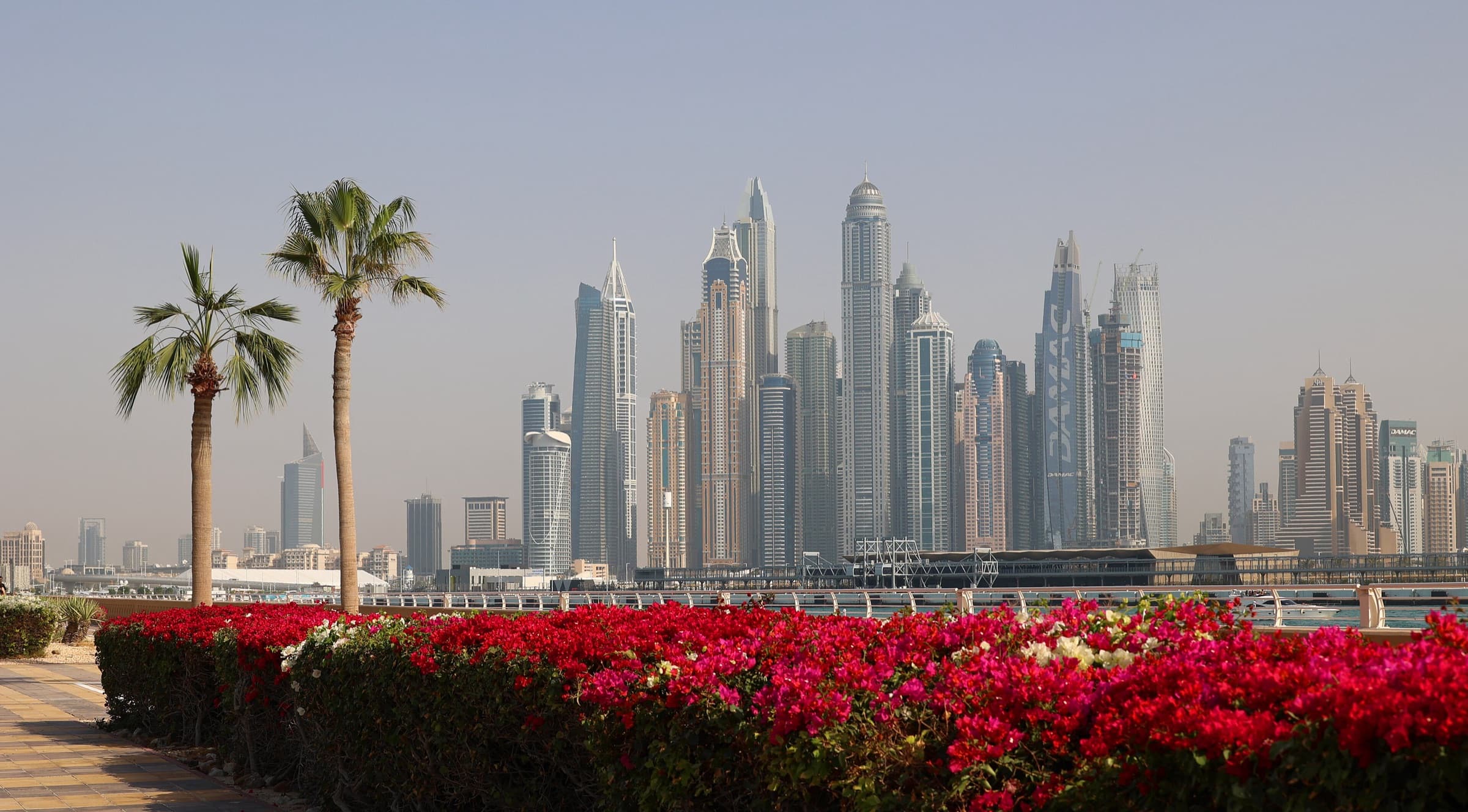Dubai Marina high-rise towers seen across the water in soft afternoon haze
